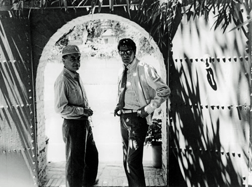 Yves Saint Laurent & Pierre Bergé at the garden gate.